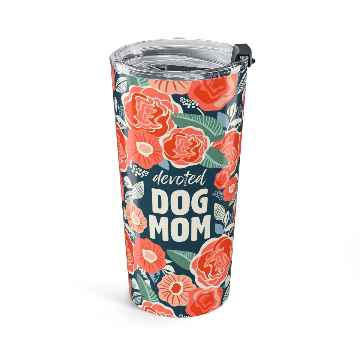 A tall insulated tumbler with a clear lid and black straw, decorated with a coral and green floral pattern on a dark navy background and the words 'devoted DOG MOM' in white text.