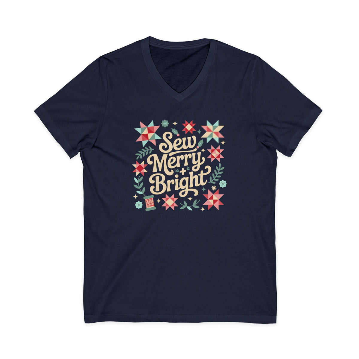 Sew Merry + Bright lettering with quilt-block stars, holly and a thread spool on a V-neck t-shirt in navy, front view – Kate Spain design for Pat Sloan