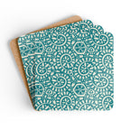 Canto Turquoise cork-backed coaster set of four, cream botanical spirals and petals on turquoise, coasters fanned out – Kate Spain design
