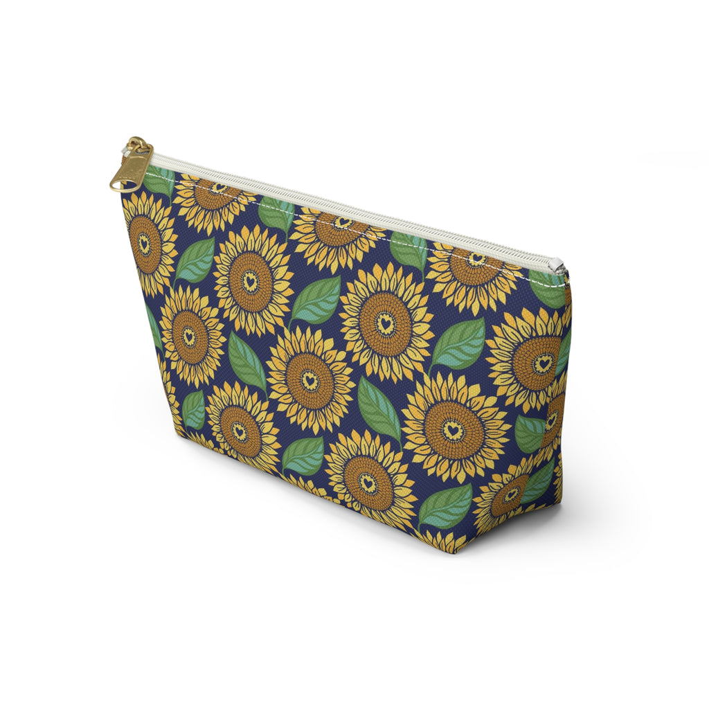Zip pouch with golden sunflowers and green leaves on navy, white zipper, angled view – Kate Spain design