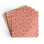 Canto Mandarin cork-backed coaster set of four, cream botanical spirals and petals on tomato red, coasters fanned out – Kate Spain design