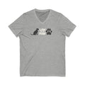 Law of the Paw® logo with seated dog and paw print on a V-neck t-shirt in athletic heather grey, front view – Kate Spain design