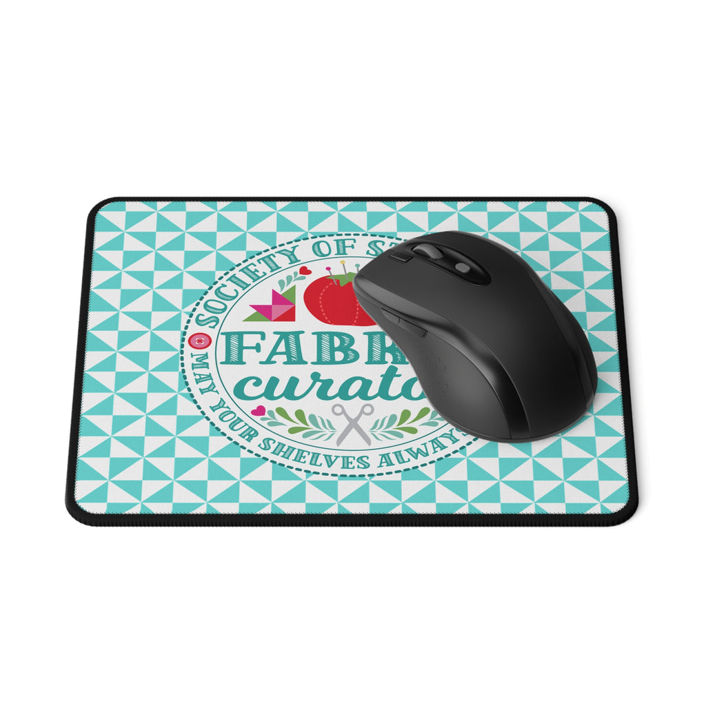 Fabric Curator Society of Stashers badge mouse pad, with a computer mouse – Kate Spain design for Pat Sloan
