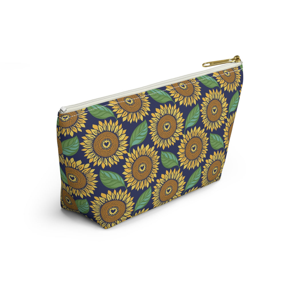 Zip pouch with golden sunflowers and green leaves on navy, white zipper, angled view – Kate Spain design