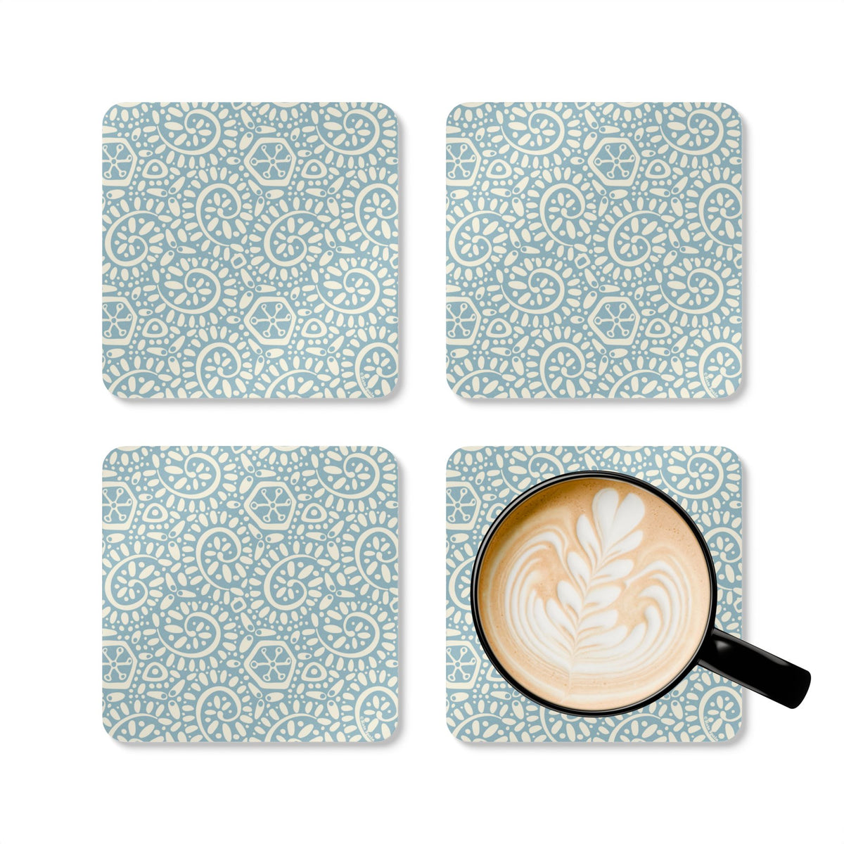 Canto Sky cork-backed coaster set of four, cream botanical spirals and petals on powder blue, four coasters with a latte mug – Kate Spain design