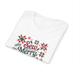 Sew Merry + Bright lettering with quilt-block stars, holly and a thread spool on a V-neck t-shirt in white, folded close-up of the design – Kate Spain design for Pat Sloan