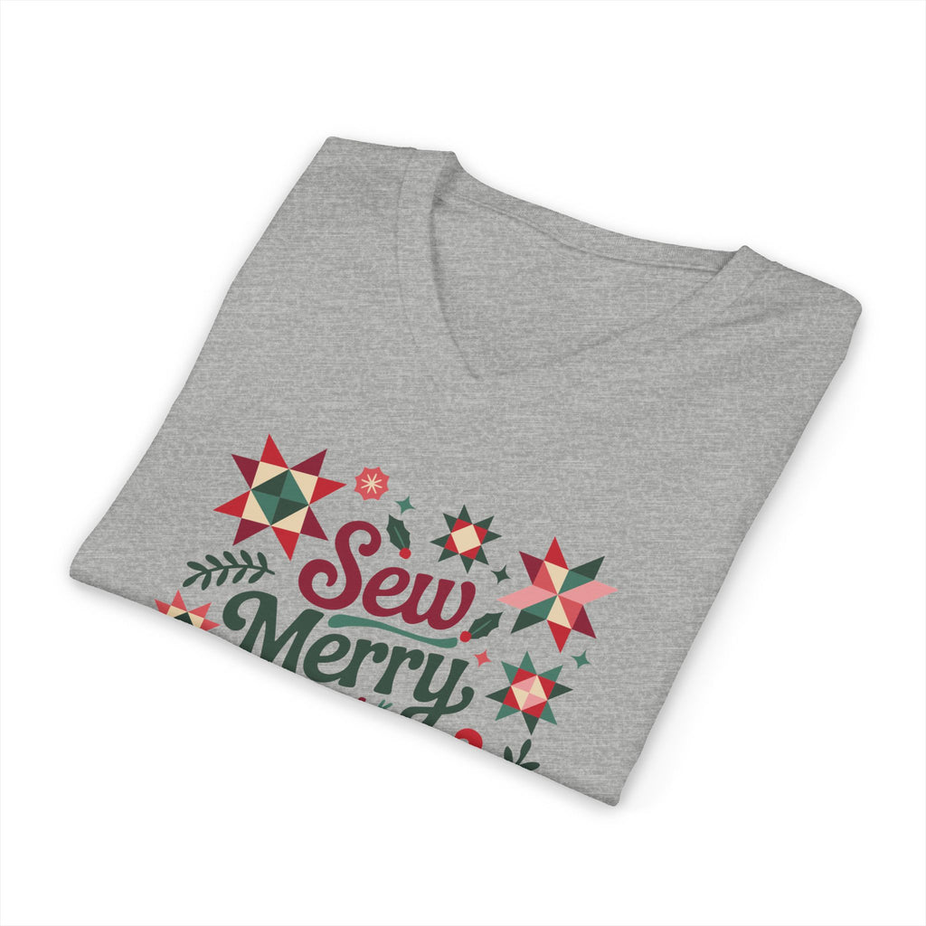 Sew Merry + Bright lettering with quilt-block stars, holly and a thread spool on a V-neck t-shirt in athletic heather grey, folded close-up of the design – Kate Spain design for Pat Sloan