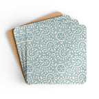 Canto Sky cork-backed coaster set of four, cream botanical spirals and petals on powder blue, coasters fanned out – Kate Spain design