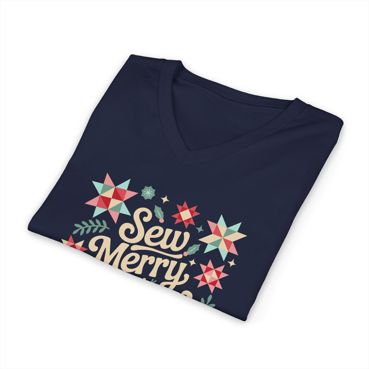 Sew Merry + Bright lettering with quilt-block stars, holly and a thread spool on a V-neck t-shirt in navy, folded close-up of the design – Kate Spain design for Pat Sloan