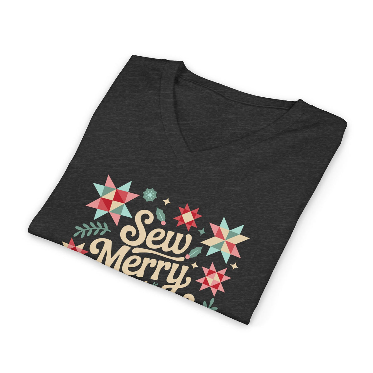 Sew Merry + Bright lettering with quilt-block stars, holly and a thread spool on a V-neck t-shirt in dark grey heather, folded close-up of the design – Kate Spain design for Pat Sloan