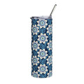 A tall, skinny tumbler with a navy blue background and a repeating floral pattern in light blue, white, and soft yellow. It has a clear lid with a black metal straw, shown on a plain white background.