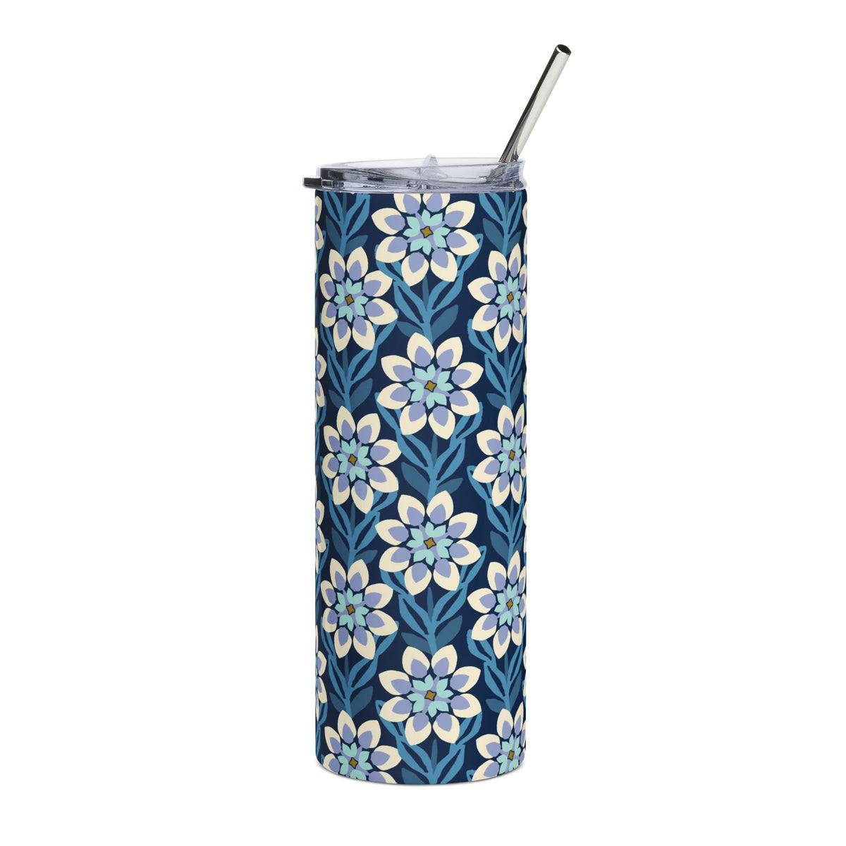 A tall, skinny tumbler with a navy blue background and a repeating floral pattern in light blue, white, and soft yellow. It has a clear lid with a black metal straw, shown on a plain white background.