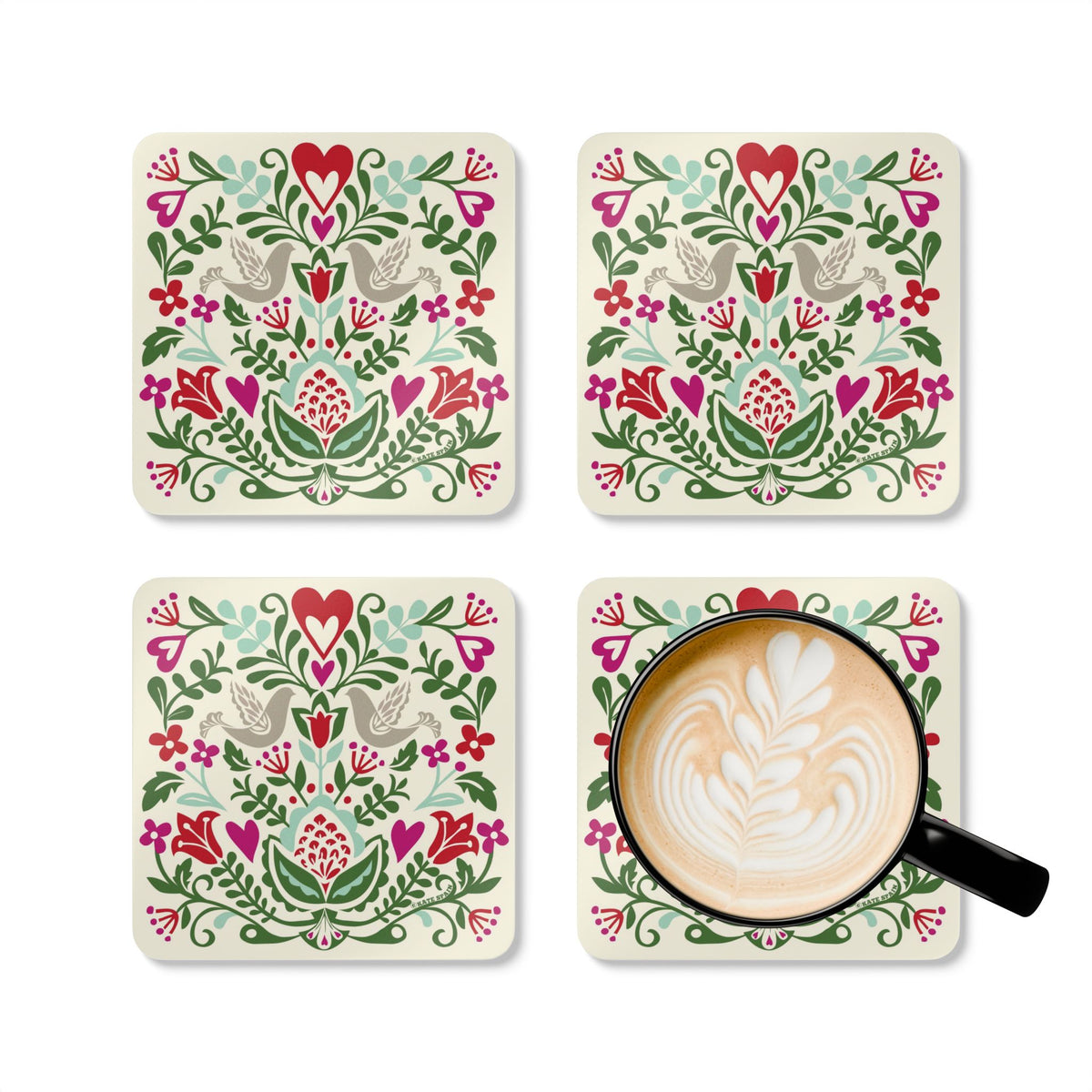 Rosemaling Snow cork-backed coaster set of four, folk-art doves, heart and tulips in red, magenta, green and aqua on cream, four coasters with a latte mug – Kate Spain design