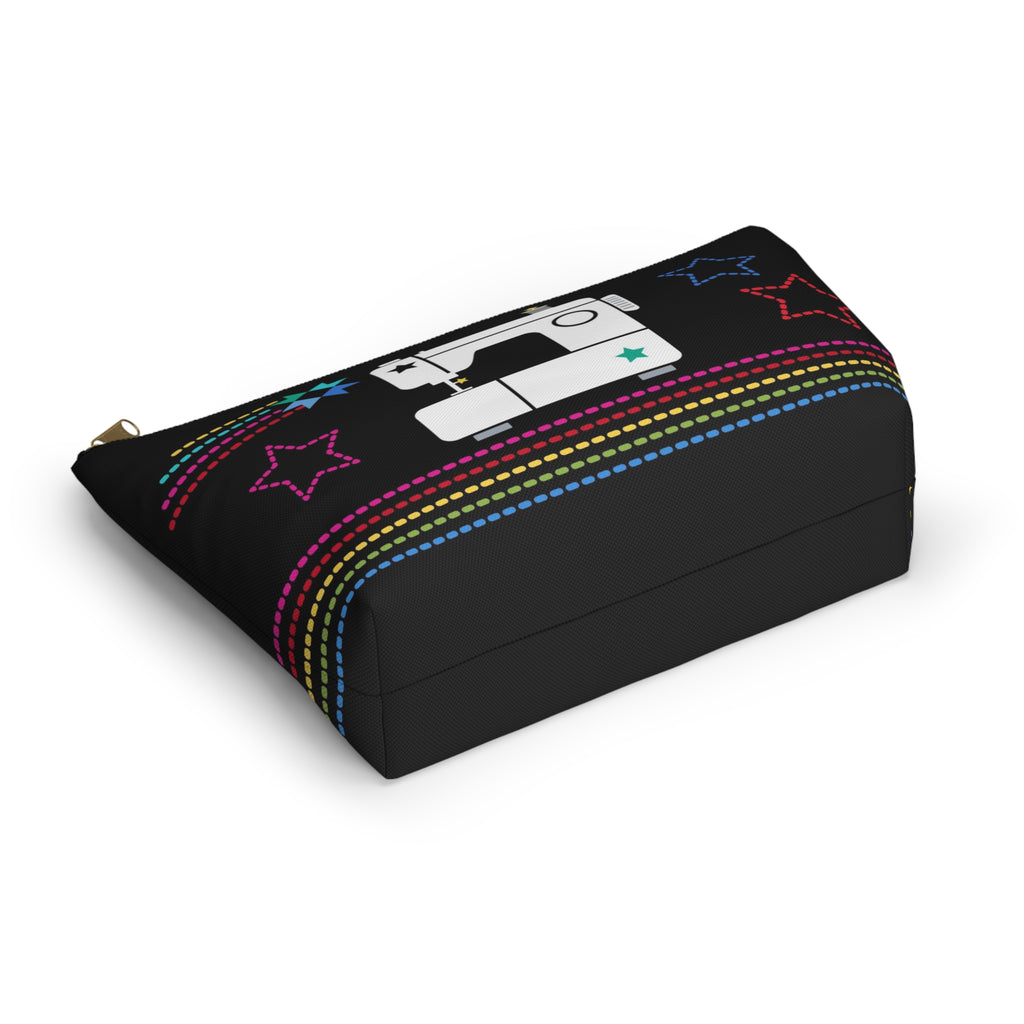 Black zip pouch with the May the ¼" Be With You sewing machine design and stars, lying flat – Kate Spain design for Pat Sloan