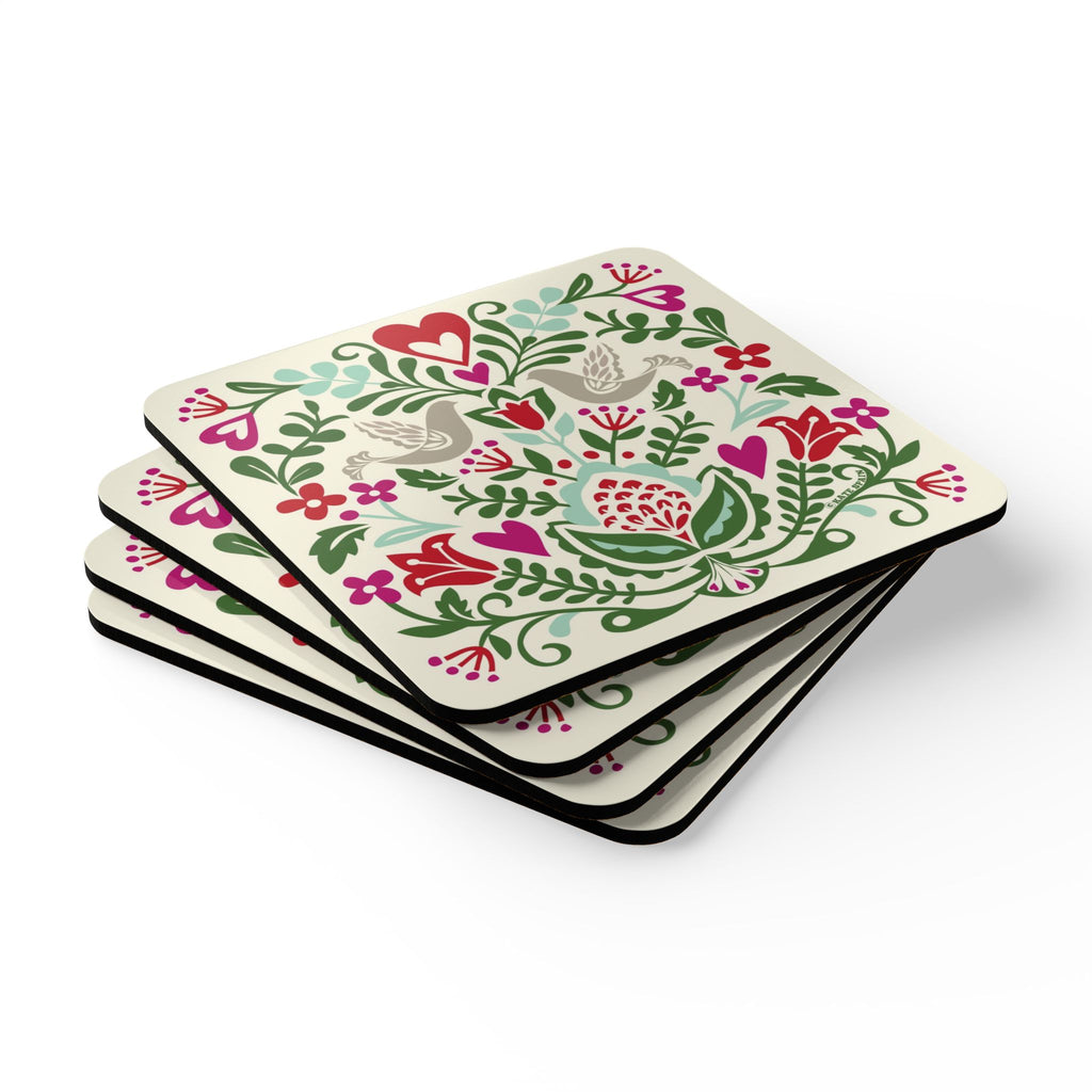 Rosemaling Snow cork-backed coaster set of four, folk-art doves, heart and tulips in red, magenta, green and aqua on cream, stacked set, angled view – Kate Spain design