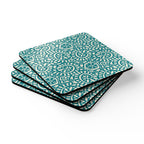 Canto Turquoise cork-backed coaster set of four, cream botanical spirals and petals on turquoise, stacked set, angled view – Kate Spain design