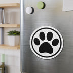 Black-and-white cat paw print die-cut magnet with a circular border, shown on a refrigerator door – Kate Spain design