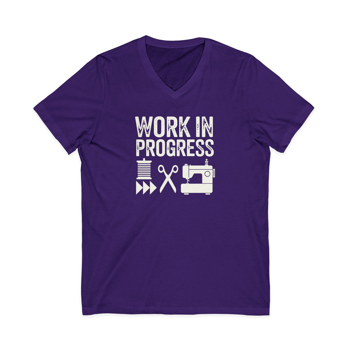 Work in Progress Mod distressed lettering with thread, scissors and sewing machine on a V-neck t-shirt in purple, front view – Kate Spain design for Pat Sloan