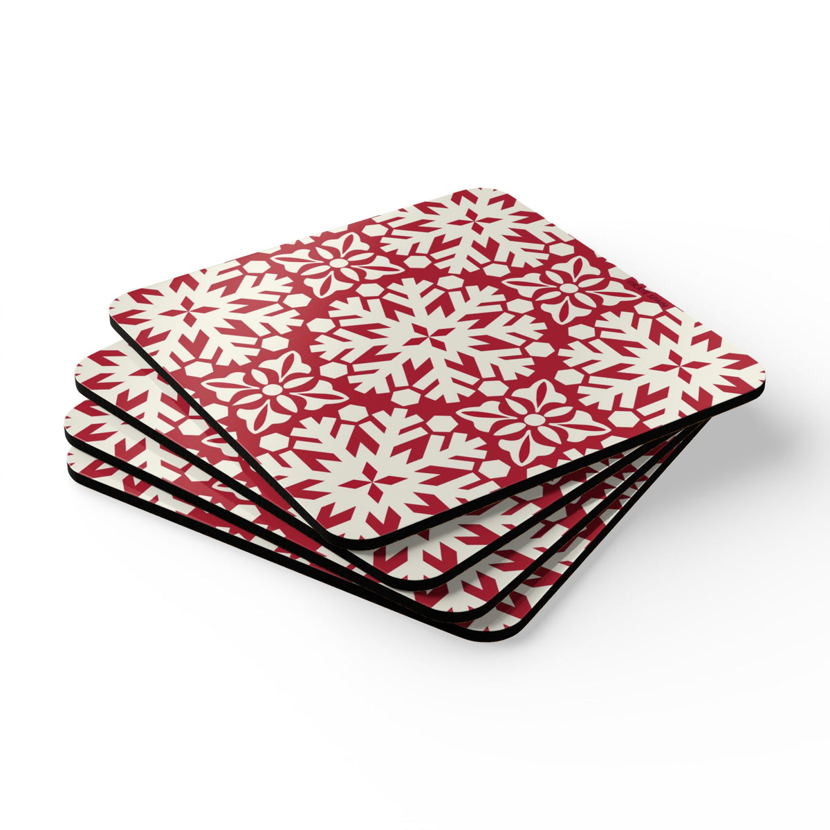 Blizzard cork-backed coaster set of four, red and cream geometric snowflake pattern, stacked set, angled view – Kate Spain design