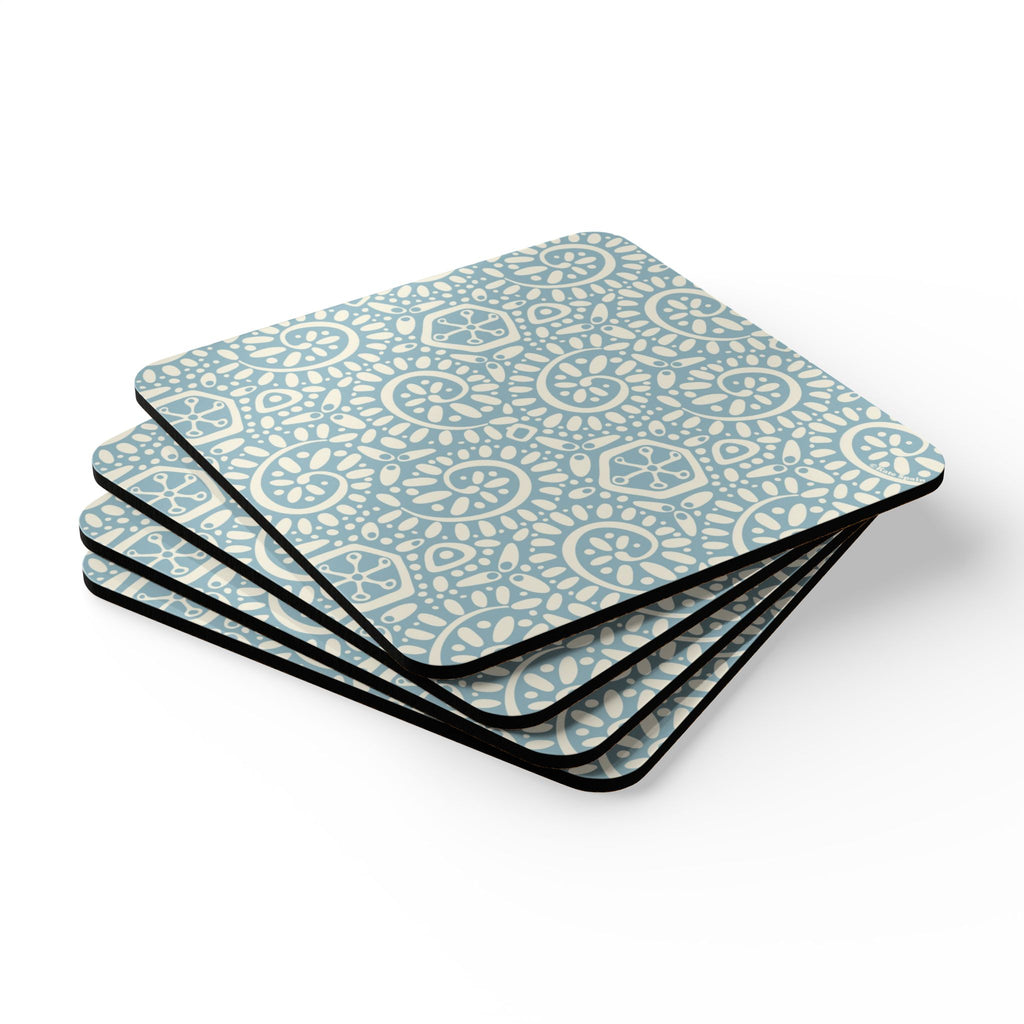 Canto Sky cork-backed coaster set of four, cream botanical spirals and petals on powder blue, stacked set, angled view – Kate Spain design