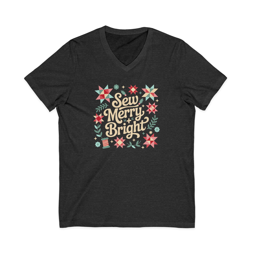 Sew Merry + Bright lettering with quilt-block stars, holly and a thread spool on a V-neck t-shirt in dark grey heather, front view – Kate Spain design for Pat Sloan