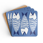 Catch of the Day cork-backed coaster set of four, white and navy stylized fish on periwinkle blue, coasters fanned out – Kate Spain design