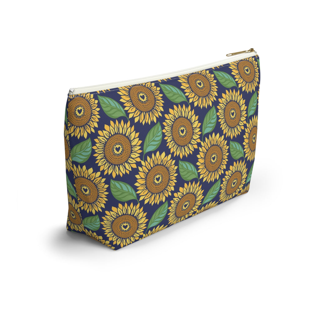 Zip pouch with golden sunflowers and green leaves on navy, white zipper, angled view – Kate Spain design