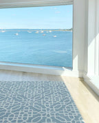 eye heart hand Atrium hand-tufted wool rug with a blue-grey and cream geometric lattice, in a sunny room overlooking the water – Kate Spain design