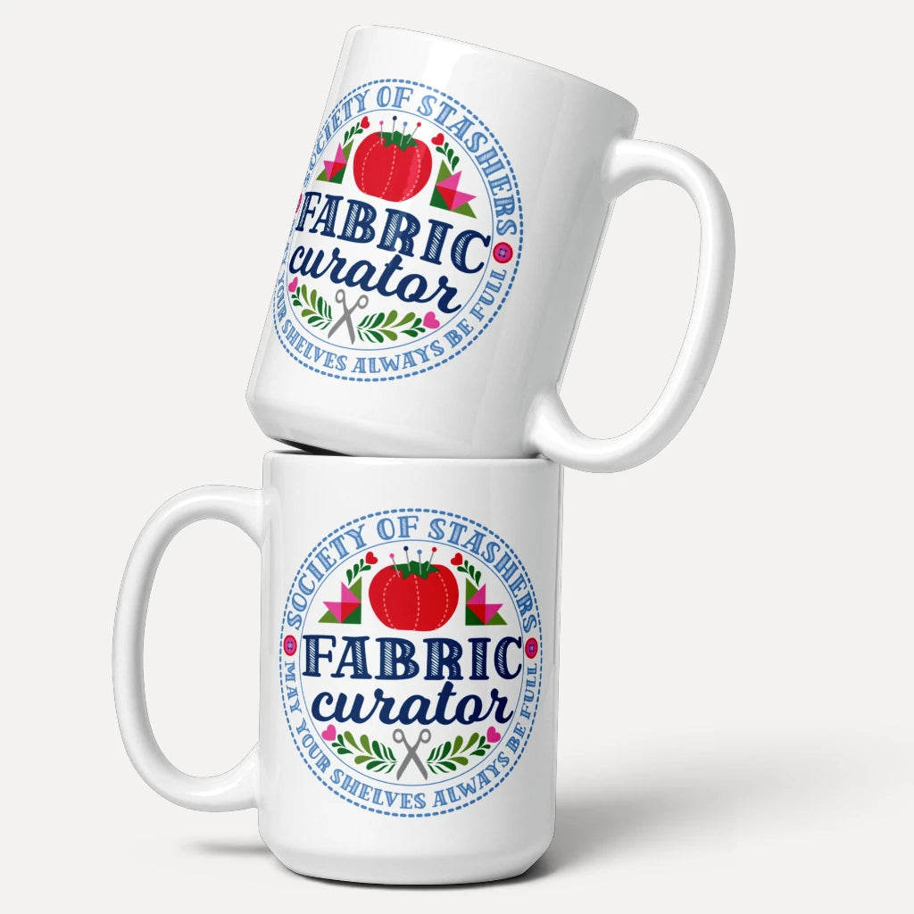 Two 15 oz ceramic mugs with the Fabric Curator Society of Stashers badge, stacked – Kate Spain design for Pat Sloan