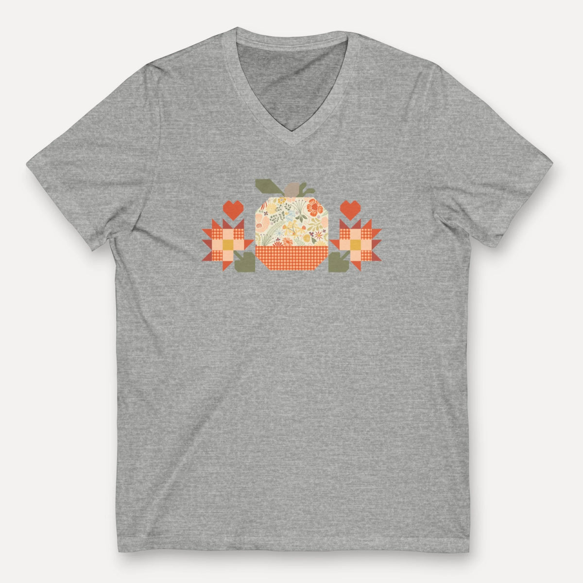 Falling for Fall patchwork pumpkin with quilt-block stars and hearts on a V-neck t-shirt in athletic heather grey, front view – Kate Spain design for Pat Sloan