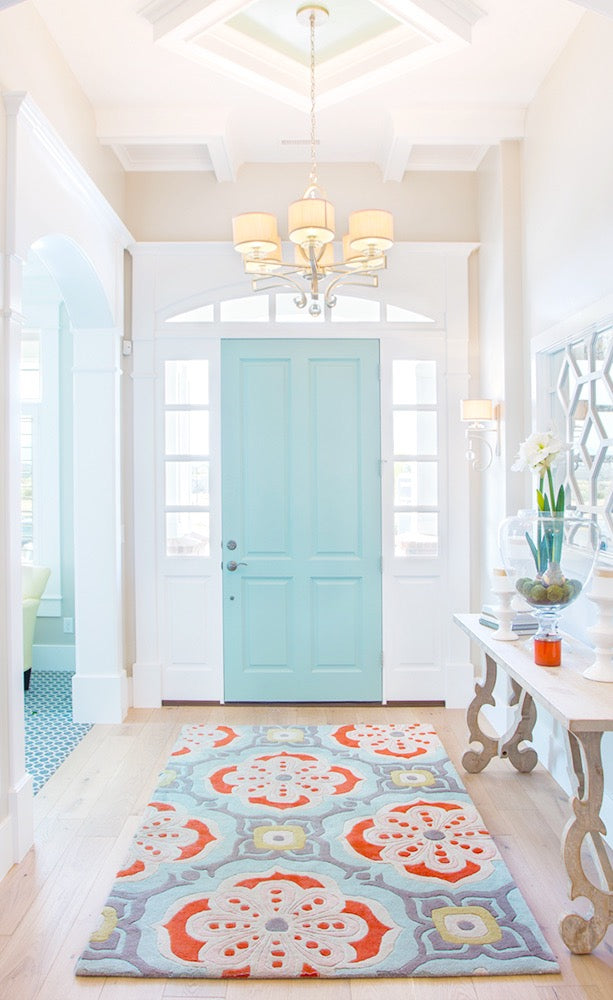 Talavera hand-tufted wool rug with a coral, blush, soft aqua and grey tile medallion pattern, in a bright entry hall – Kate Spain design