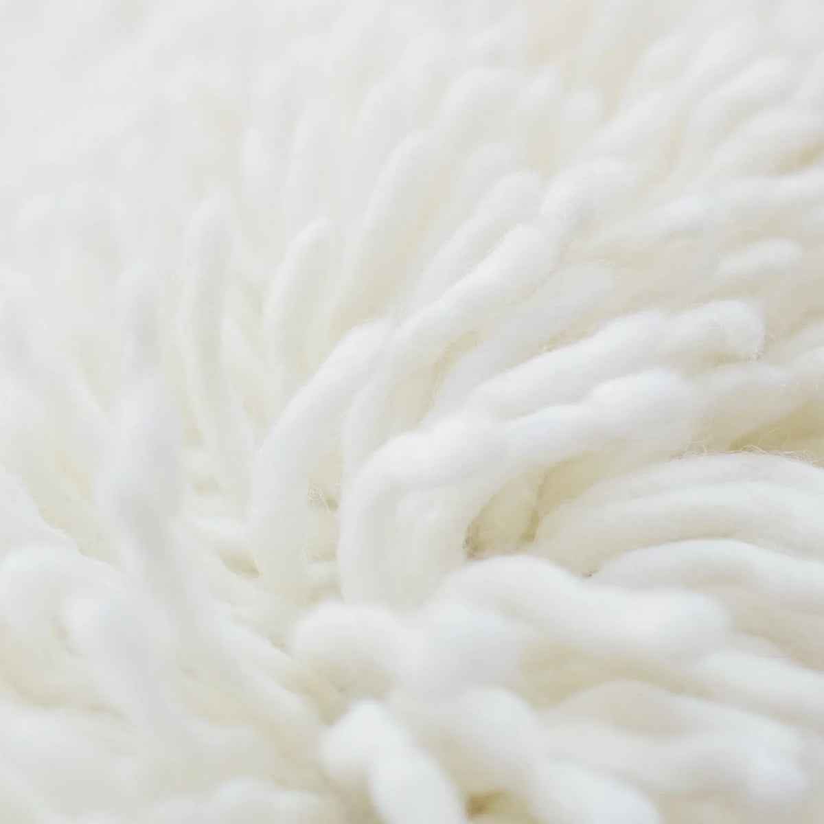 nothing to hide hand-knotted shag throw rug in undyed natural white New Zealand wool, extreme close-up of the wool – Kate Spain design