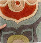 Talavera hand-tufted wool rug with a coral, blush, soft aqua and grey tile medallion pattern, close-up of the carved wool pile – Kate Spain design