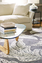 eye heart hand Taupe Leaf hand-tufted wool rug with oversized cream leaves on taupe, under a glass coffee table in a living room – Kate Spain design