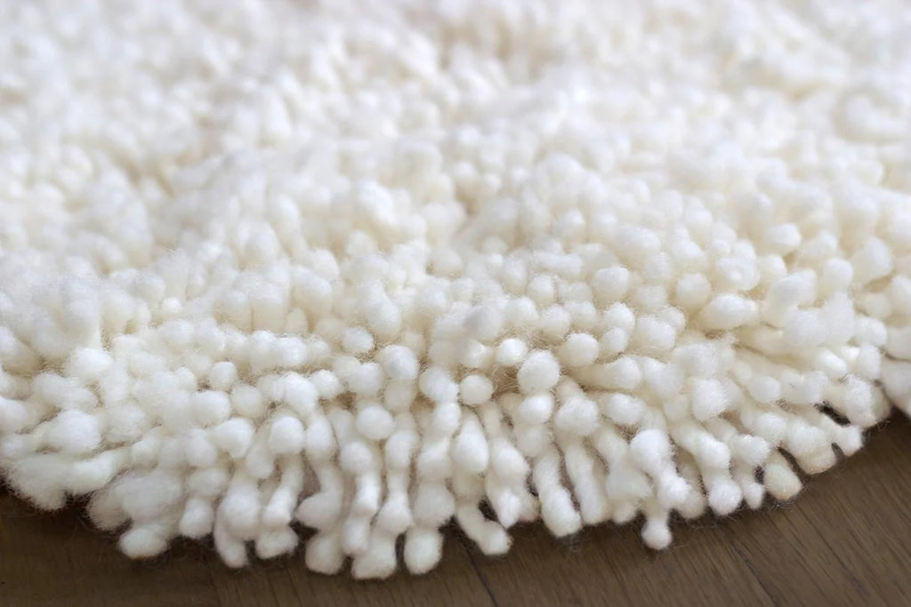 nothing to hide hand-knotted shag throw rug in undyed natural white New Zealand wool, close-up of the long wool pile – Kate Spain design