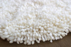 nothing to hide hand-knotted shag throw rug in undyed natural white New Zealand wool, close-up of the long wool pile – Kate Spain design