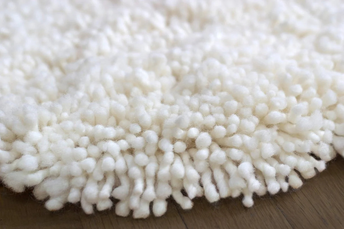 nothing to hide hand-knotted shag throw rug in undyed natural white New Zealand wool, close-up of the long wool pile – Kate Spain design