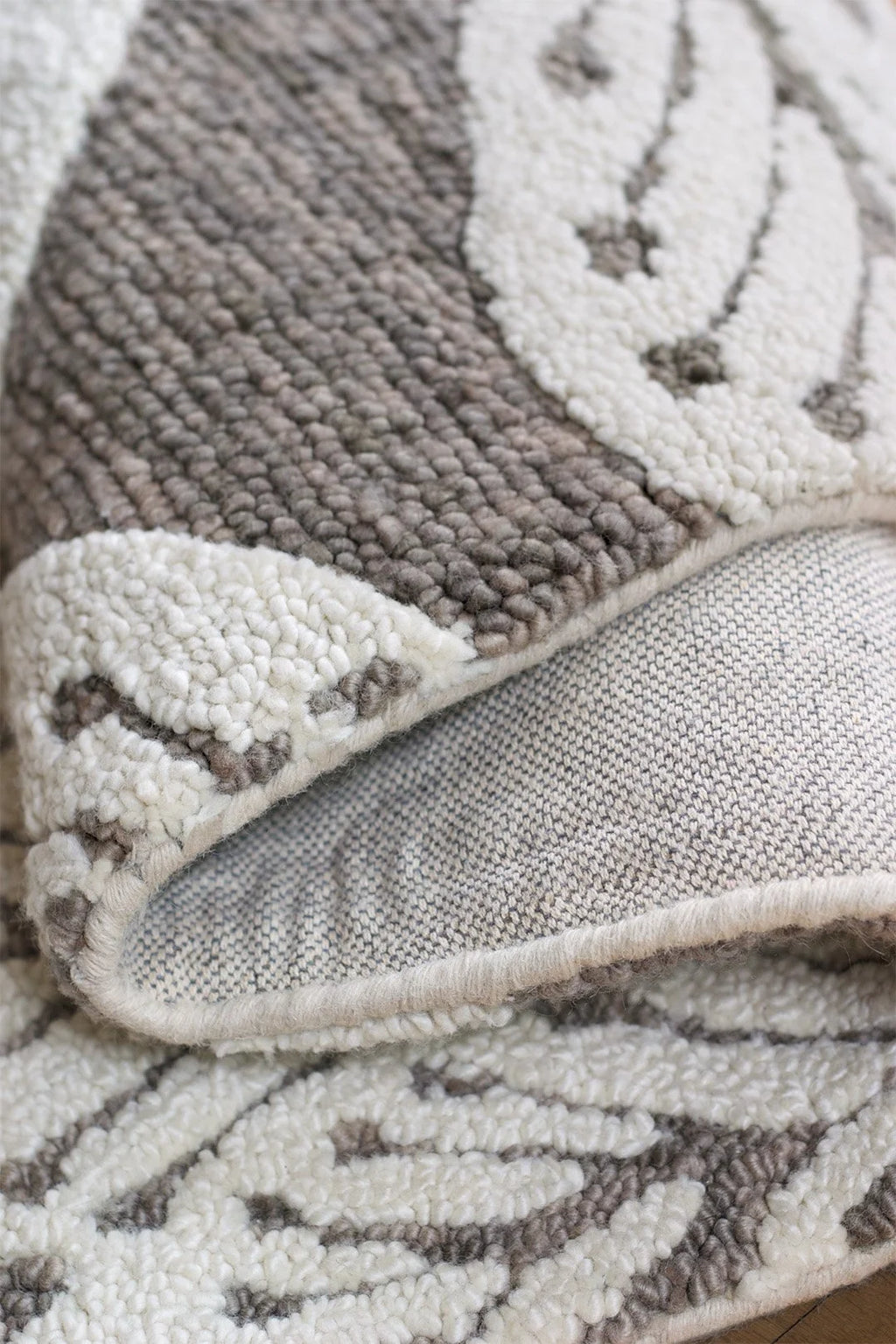 eye heart hand Taupe Leaf hand-tufted wool rug with oversized cream leaves on taupe, corner turned up to show the back and looped pile – Kate Spain design