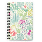 Desert spiral notebook with pale green succulents and cacti with coral and magenta blooms on cream, front cover – Kate Spain design