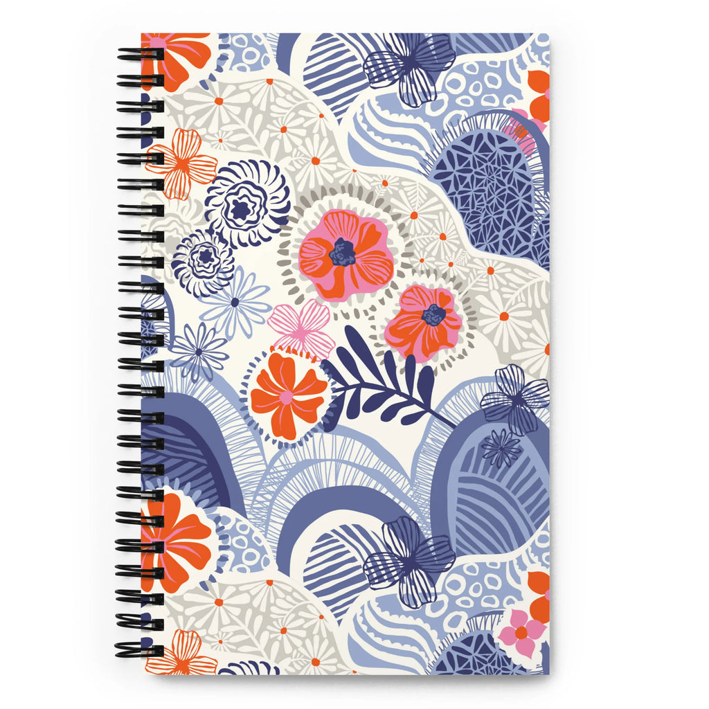 Hills + Valleys spiral notebook with layered periwinkle hills dotted with orange, coral and pink flowers on cream, front cover – Kate Spain design