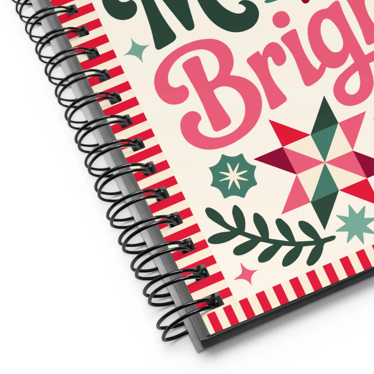 Sew Merry + Bright spiral notebook with quilt-block stars and holly, close-up of the spiral binding – Kate Spain design for Pat Sloan