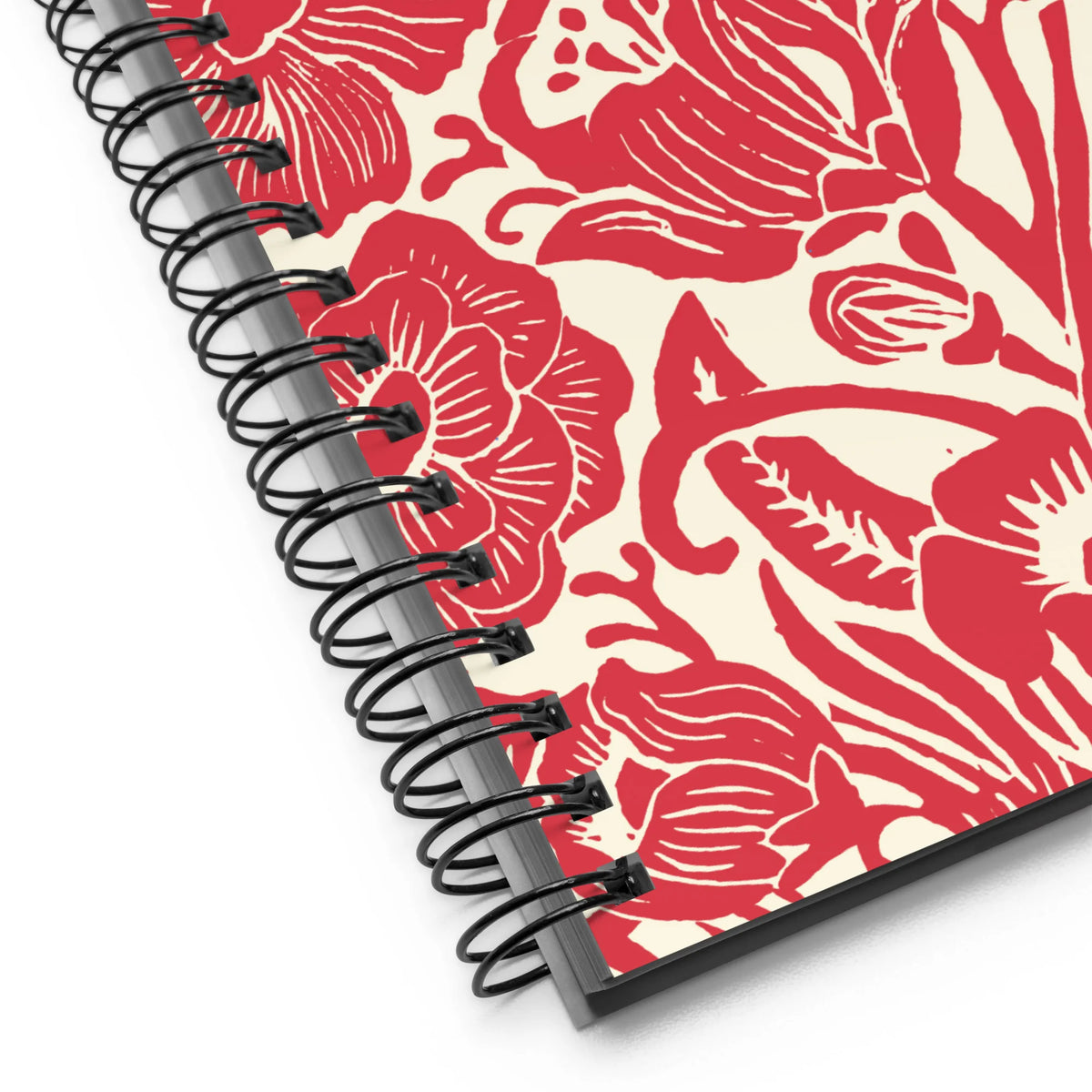 Meadow spiral notebook in Poppy, close-up of the spiral binding with red block-print flowers – Kate Spain design