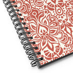 Earth spiral notebook in Clay, clay-red block-print medallions on cream, close-up of the spiral binding – Kate Spain design