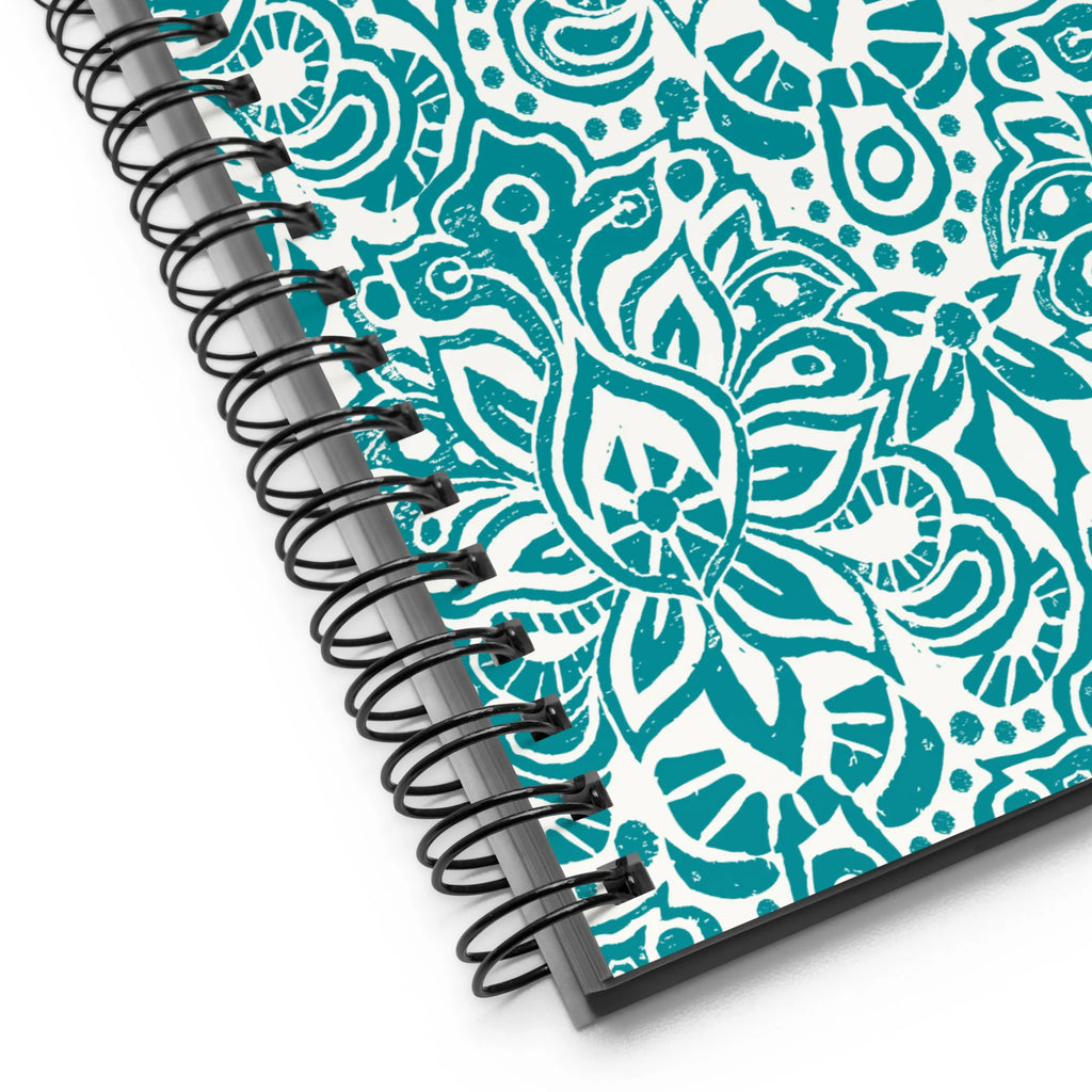 Earth spiral notebook in Turquoise, turquoise block-print medallions on cream, close-up of the spiral binding – Kate Spain design