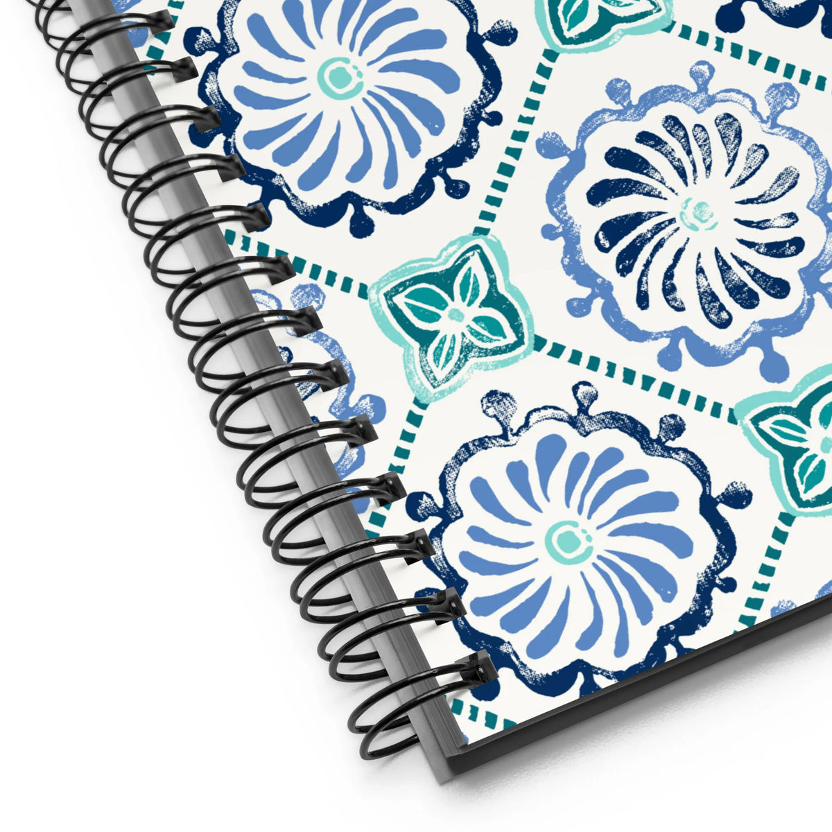 Horizon Tile spiral notebook with blue and teal pinwheel tile medallions on cream, close-up of the spiral binding – Kate Spain design