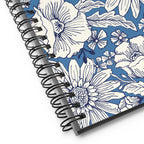 Jardin Blue spiral notebook with white line-drawn florals on cornflower blue, close-up of the spiral binding – Kate Spain design