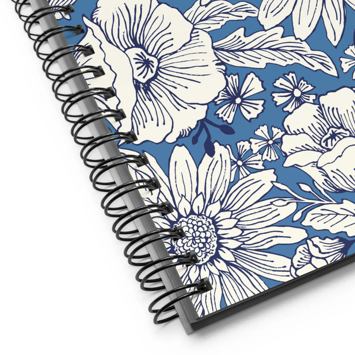 Jardin Blue spiral notebook with white line-drawn florals on cornflower blue, close-up of the spiral binding – Kate Spain design