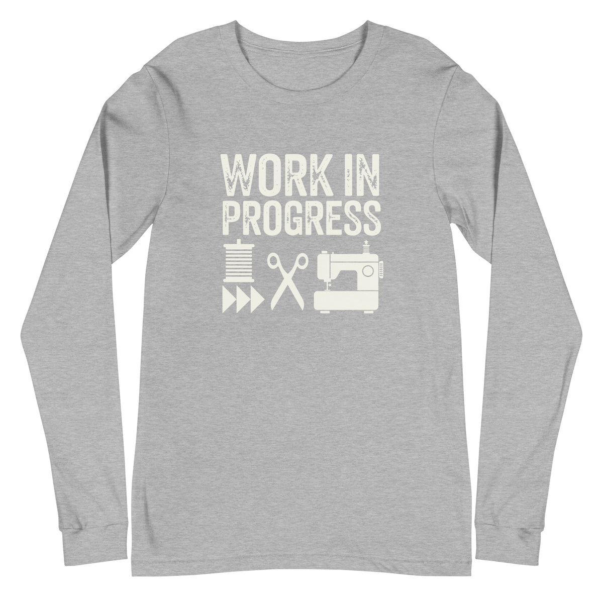 Work in Progress lettering with spool, scissors and sewing machine icons on a unisex long-sleeve tee in athletic heather grey, front view – Kate Spain design for Pat Sloan