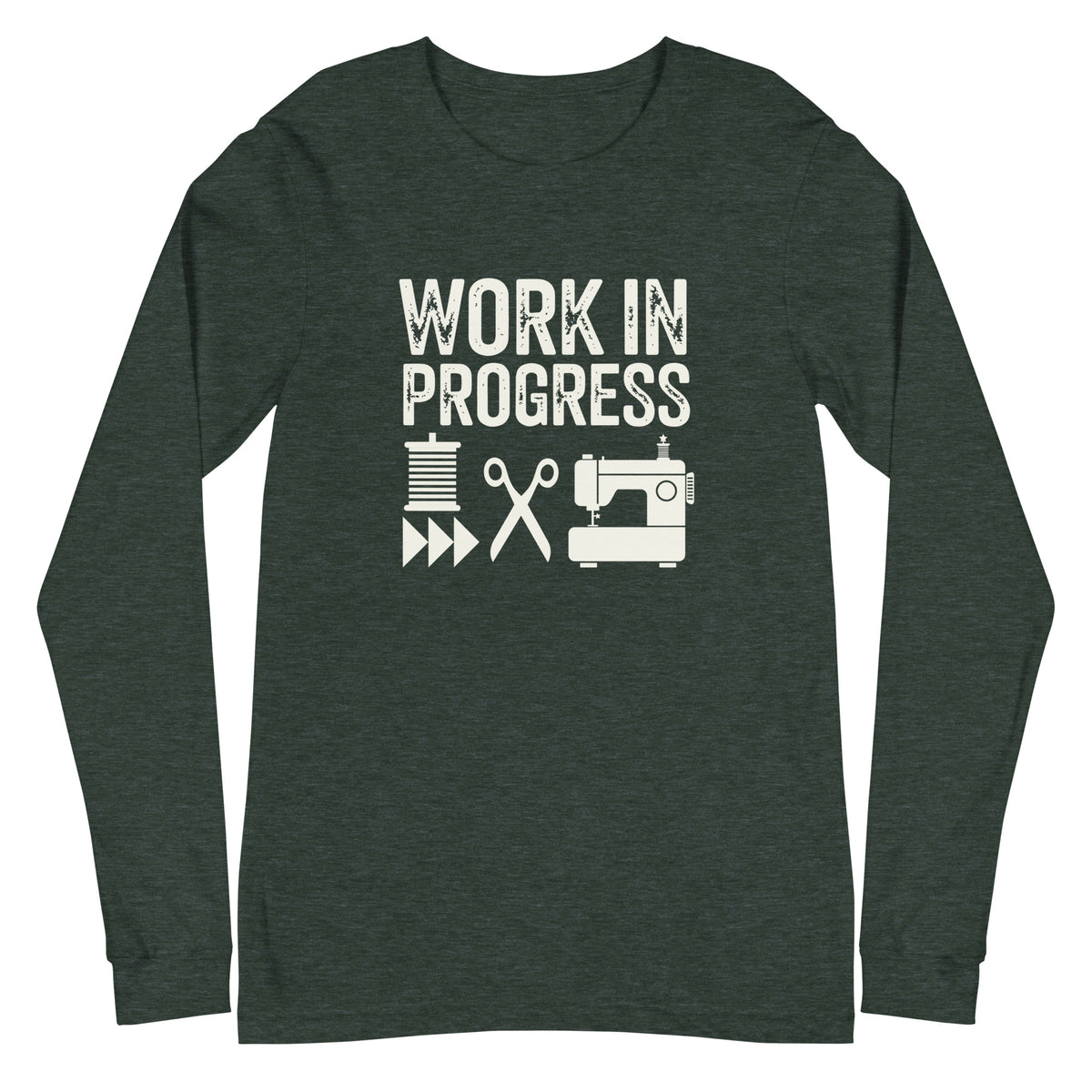 Work in Progress lettering with spool, scissors and sewing machine icons on a unisex long-sleeve tee in heather forest green, front view – Kate Spain design for Pat Sloan