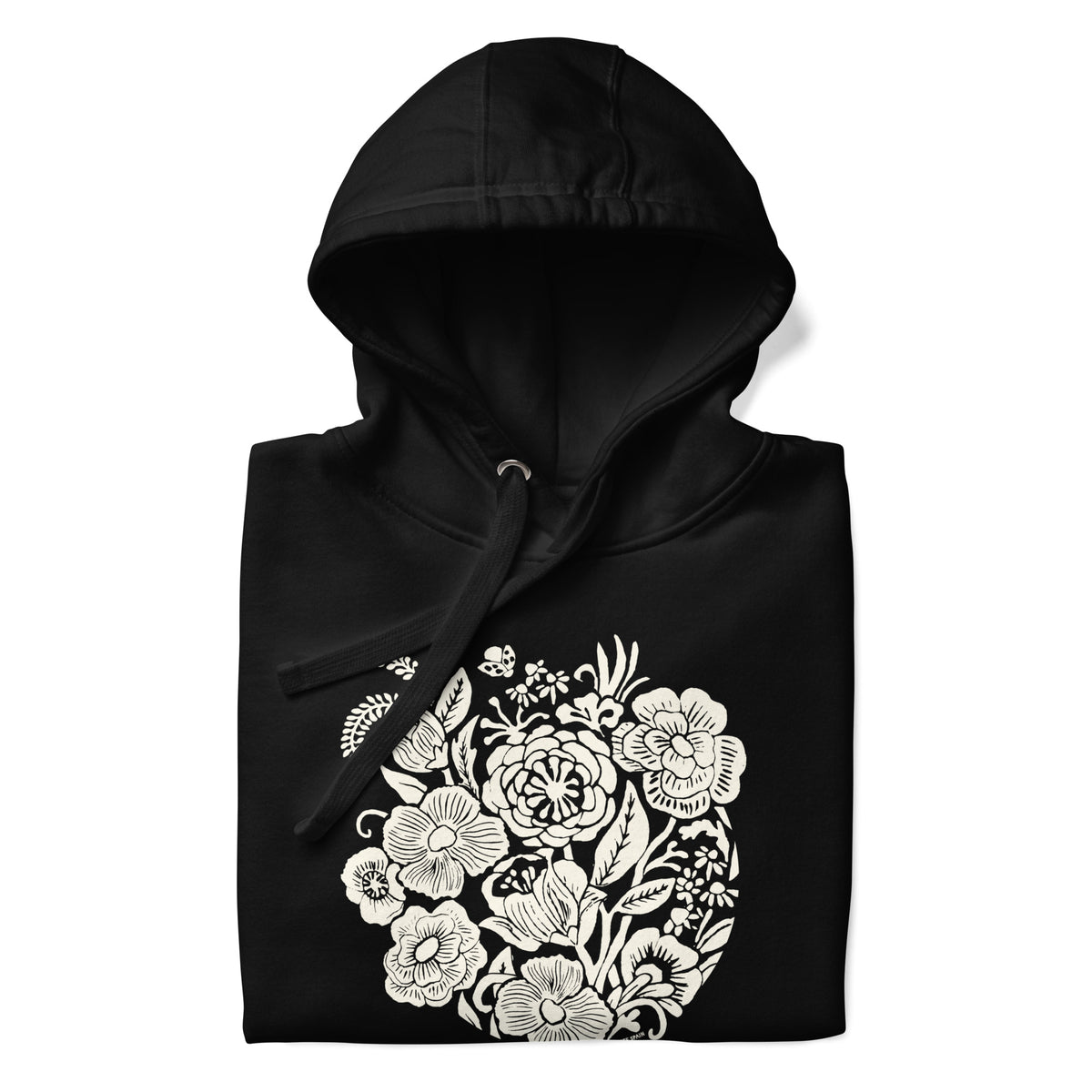 Meadowsweet woodblock-style bouquet of wildflowers on a pullover hoodie in black, folded close-up of the design – Kate Spain design